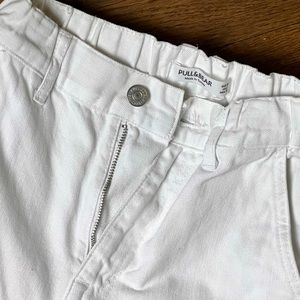 White cargo pants, 6 pockets, elastic at bottom of the leg